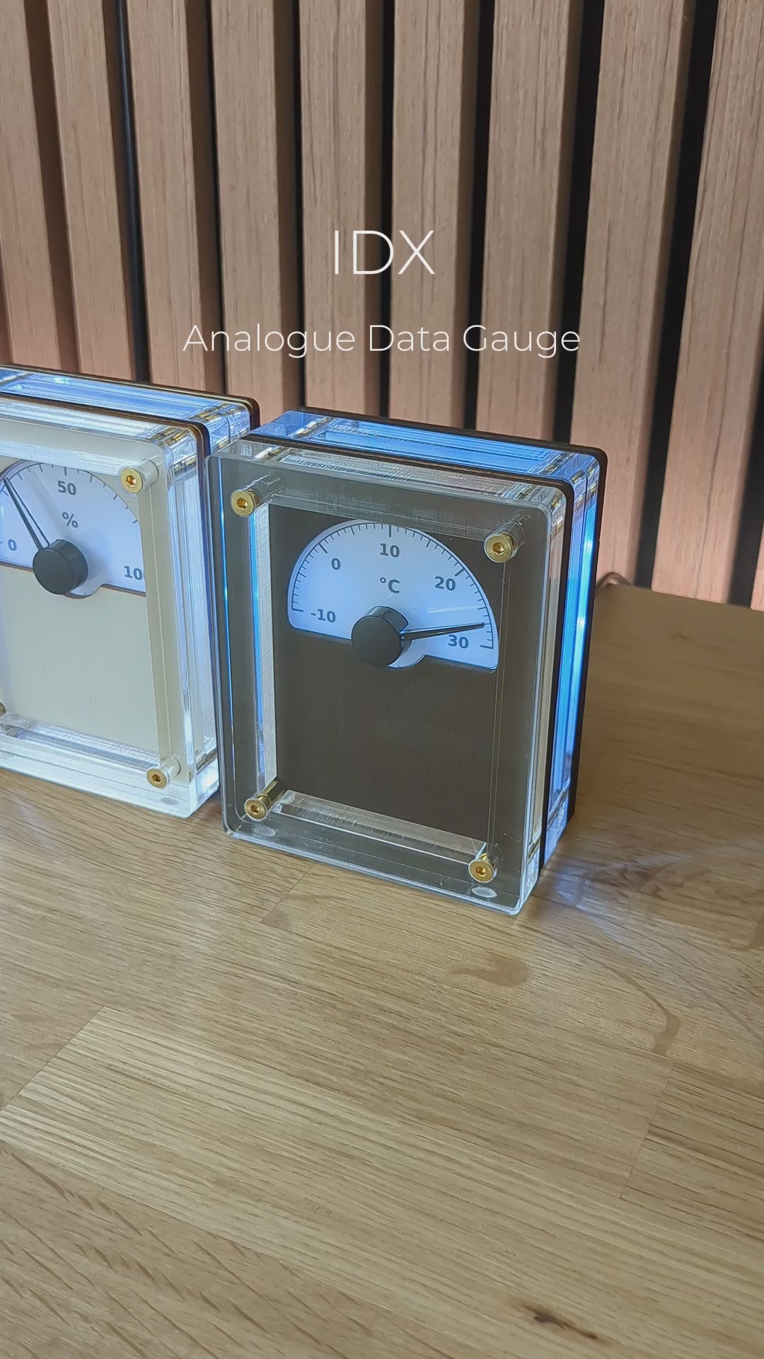 A view of three IDX Analogue Data Gauges together on a wooden desk